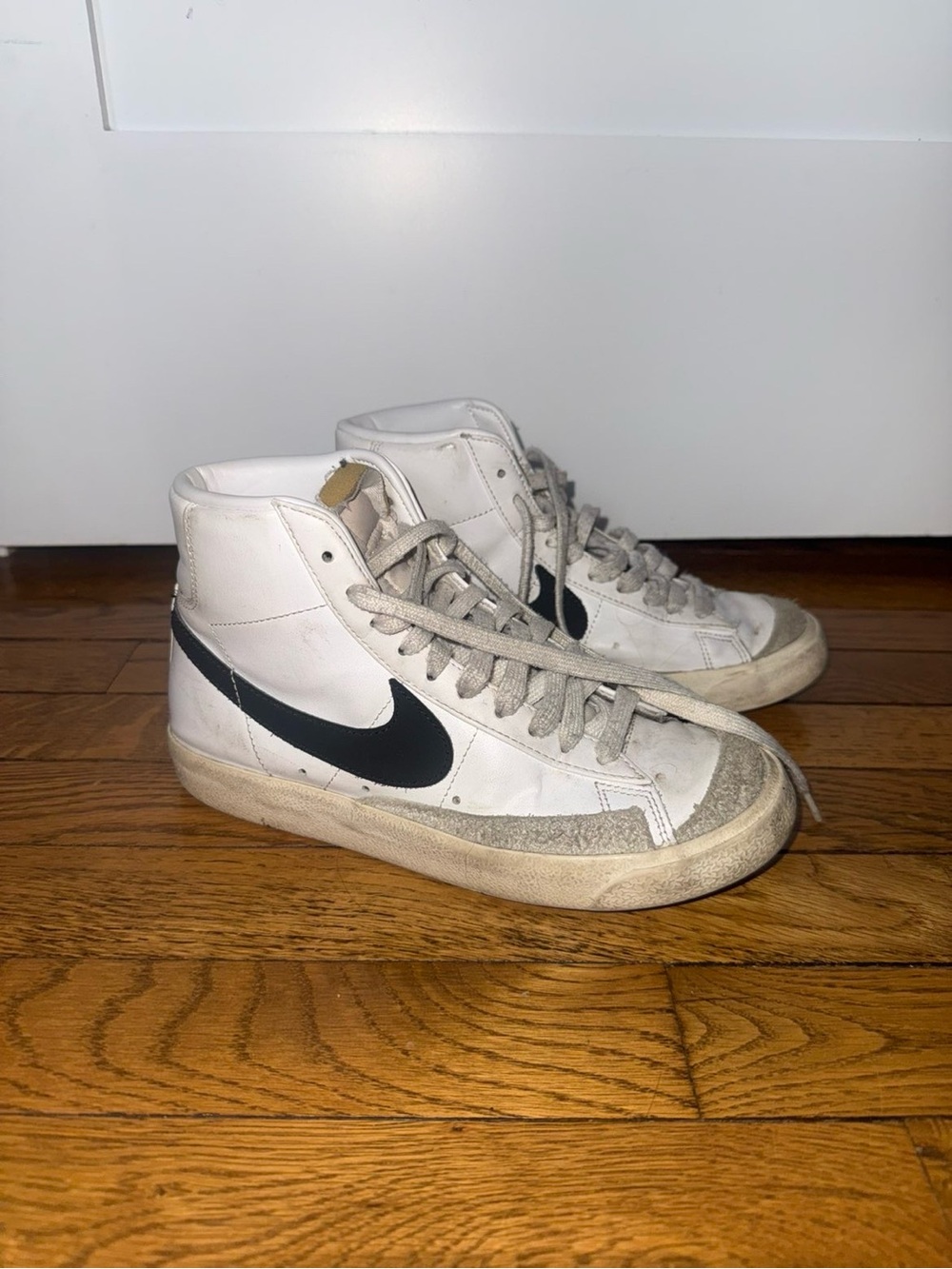 Nike White High-Top Sneakers with Black Swoosh